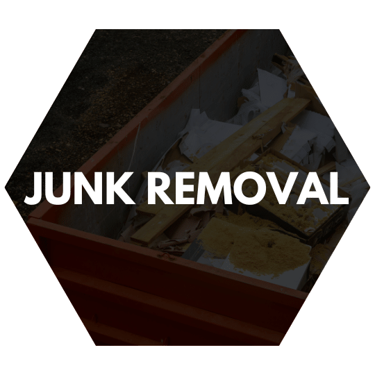 A dumpster filled with wood, drywall, and other debris during a junk removal project.