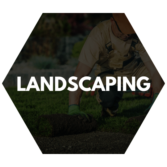 A professional landscaper laying down fresh sod to create a lush green lawn.