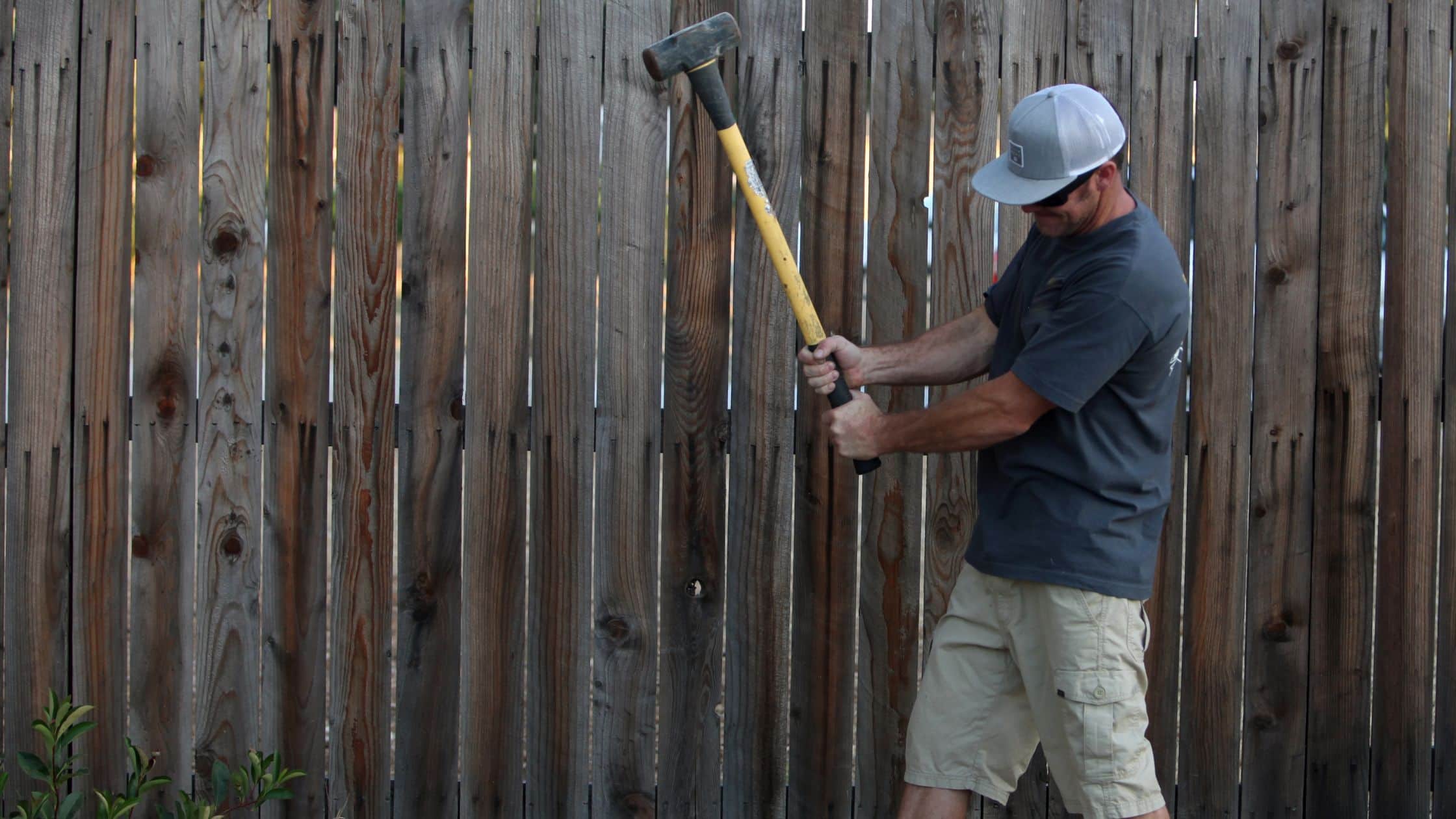 Colin Can Help crew removing an old wooden fence efficiently for a homeowner in Mayfield Heights.