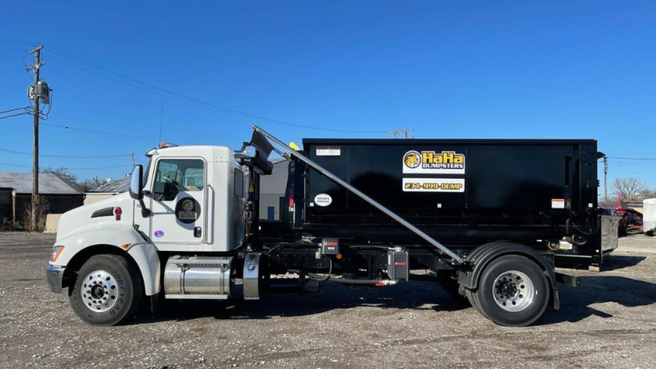 HaHa Dumpsters truck with a roll-off dumpster ready for delivery in Euclid, Ohio.